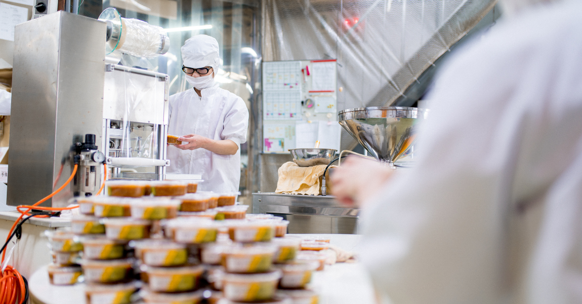 People in a lab putting labels onto food packages