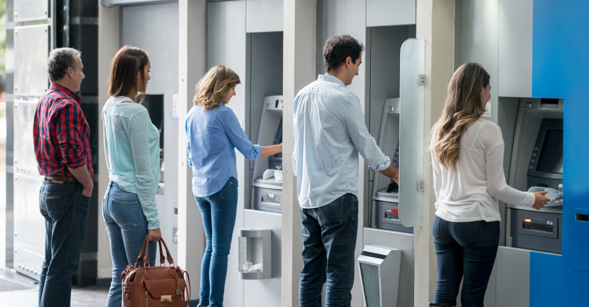 People using line of ATMs outside